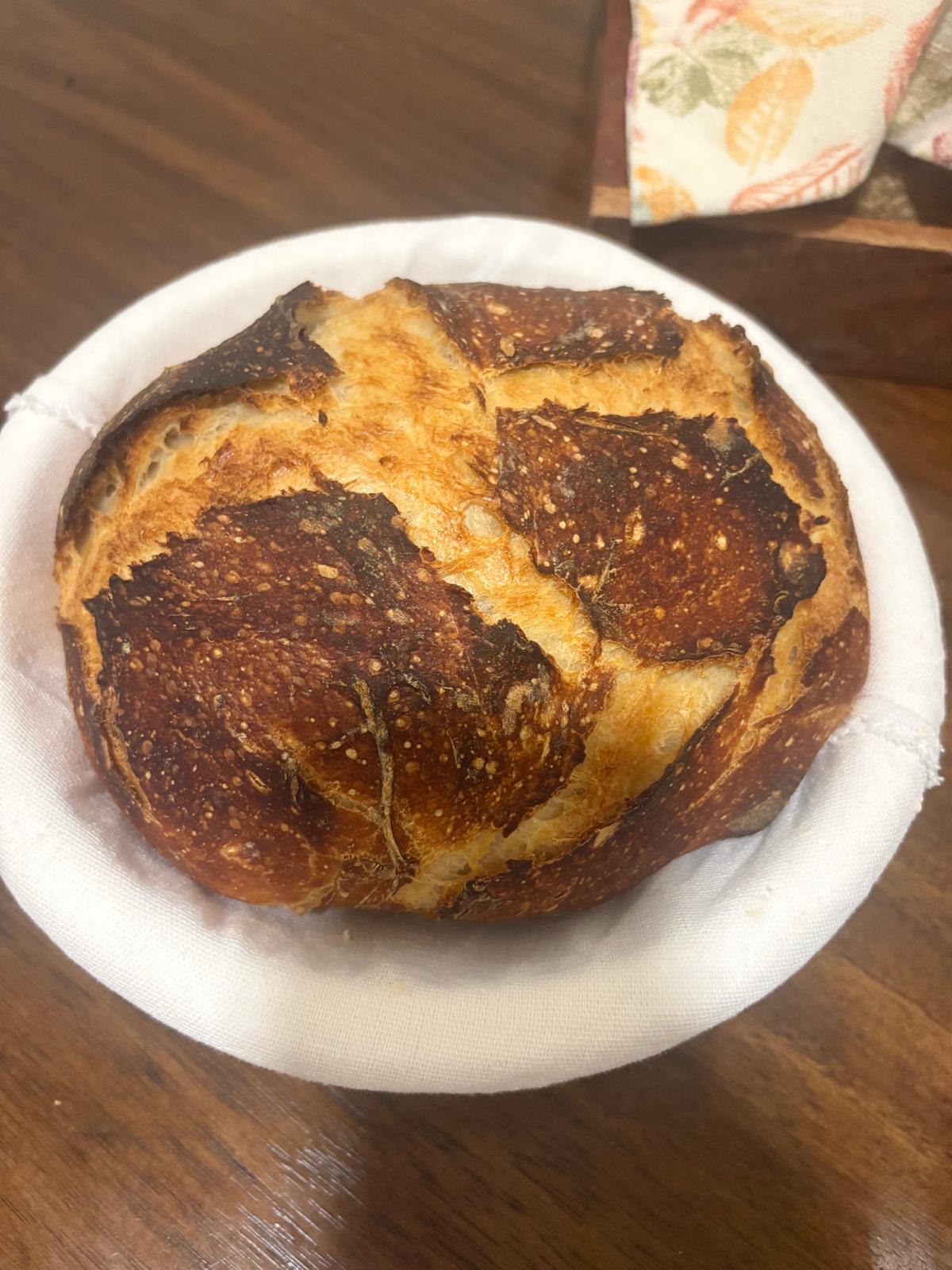 An image of a freshly baked sourdough loaf on a plate.